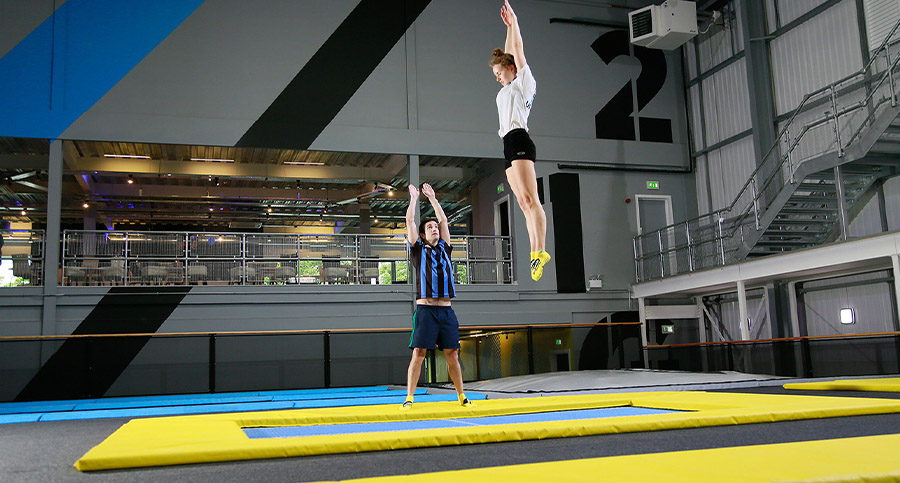 person being instructed in a trampoline park