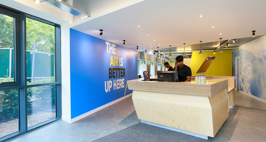 leisure centre reception area with branded wall design