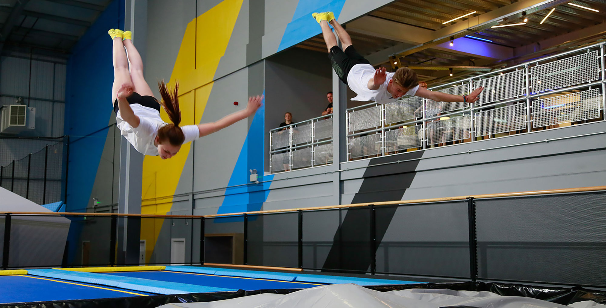 people performing flips in a large leisure centre