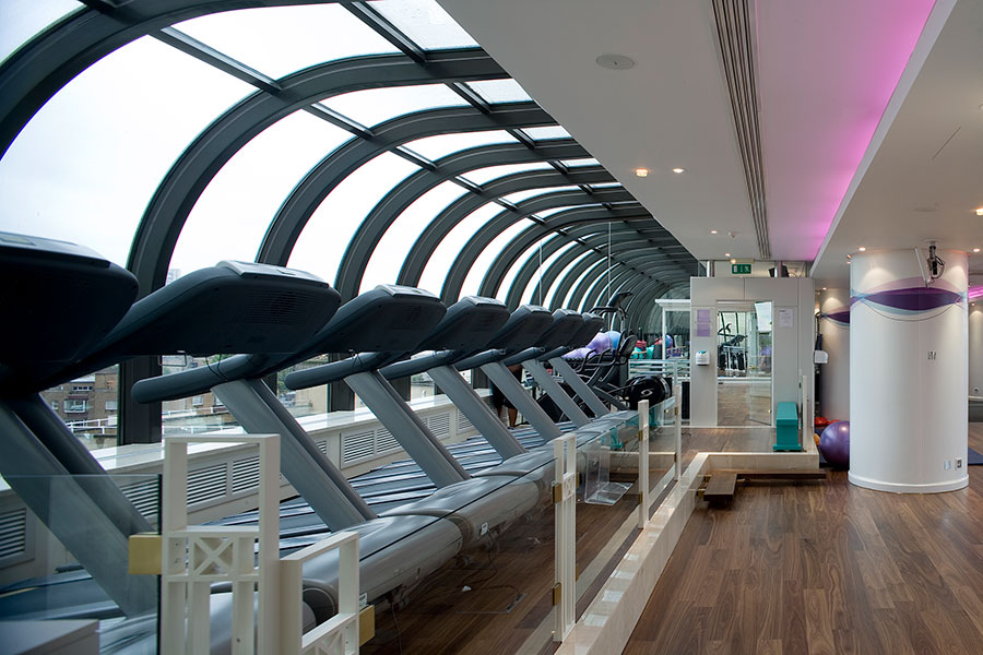 a row of treadmills in a hotel gym