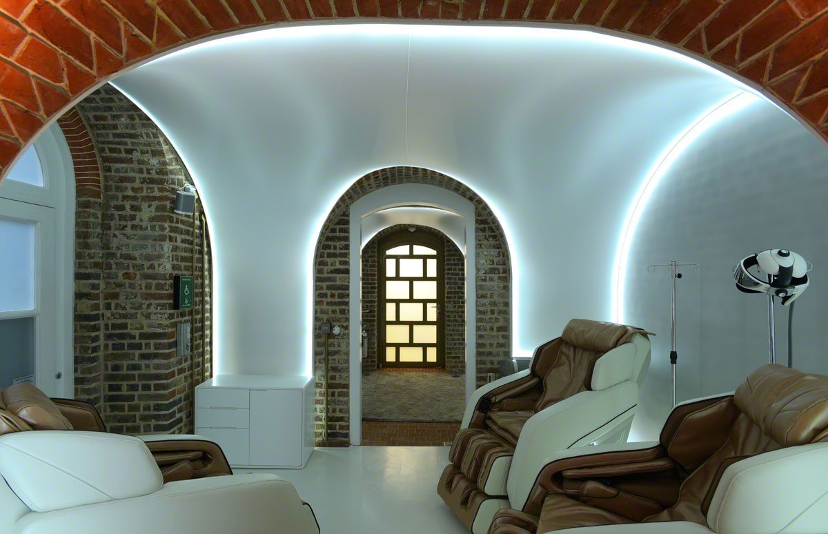 massage chairs in a small brick room